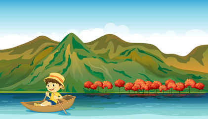 Wall Mural - A river and a smiling boy in a boat