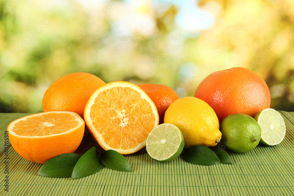 Fruits with leafs on table on bright background