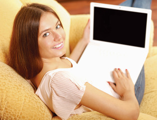 Beautiful happy smiling woman sitting on the sofa