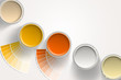 Five paint cans - yellow, orange, white on white background