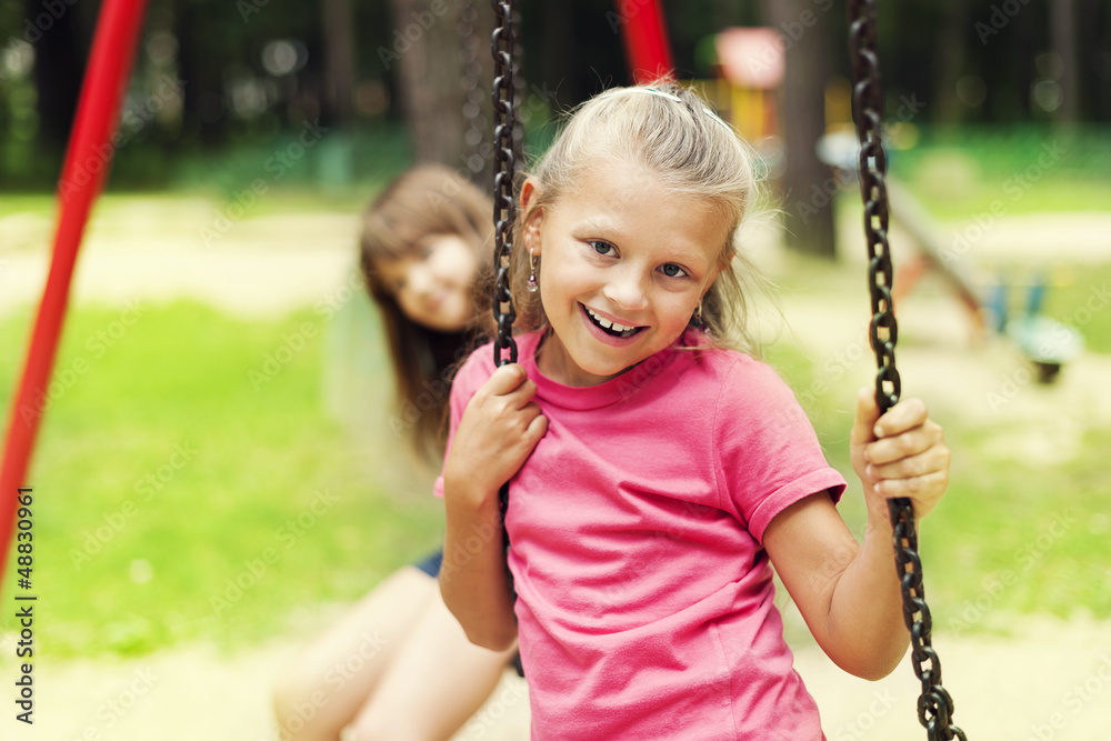 Happy little girl on swing Stock Photo | Adobe Stock