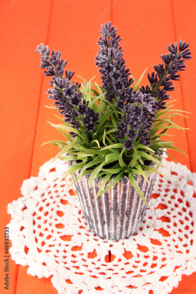 Decorative lavender in vase on wooden table close-up