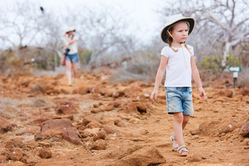 Wall Mural - little girl hiking at scenic terrain
