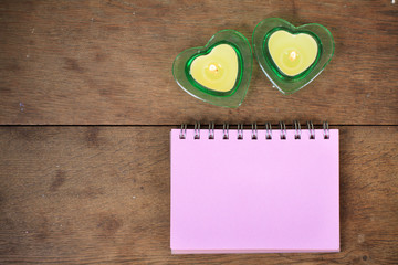 Wall Mural - Heart shape burning candles, message paper on wooden background