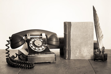 Fototapete - Vintage phone, old book, quill and inkwell on wooden table