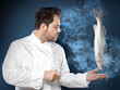 Male chef with levitating seabass fish