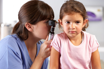 Wall Mural - Doctor Examining Child's Ears In Doctor's Office