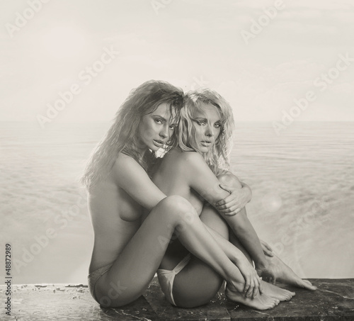 Fototapeta na wymiar Amazing nude women close to the water