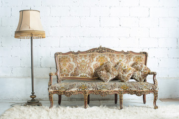 Vintage luxury sofa with lamp in white room