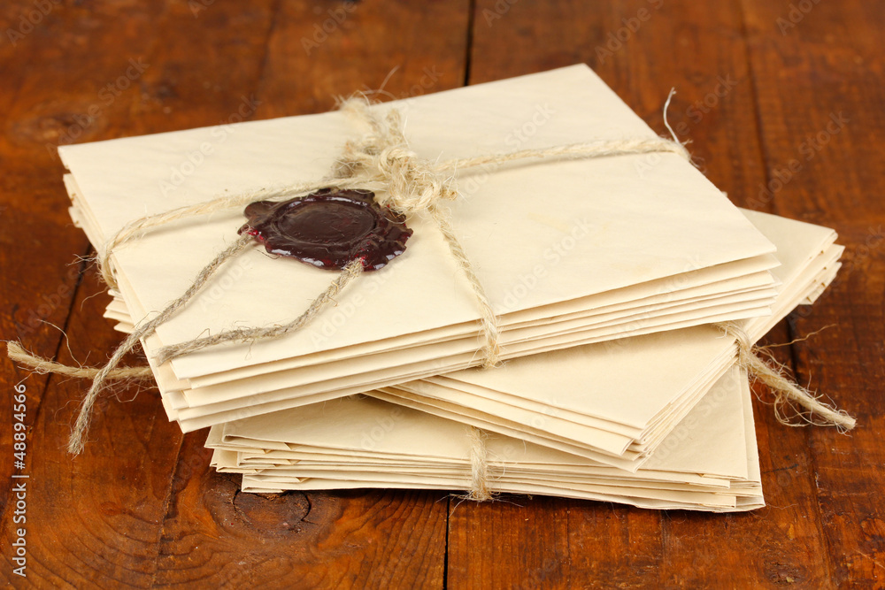 Stacks of old letters on wooden table