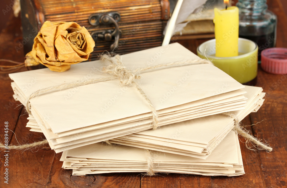 Stacks of old letters on wooden table
