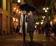 © Nejron Photo - Elegant couple with umbrella outdoors on rainy evening