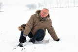 Fototapeta Młodzieżowe - Senior man with injured leg on snow