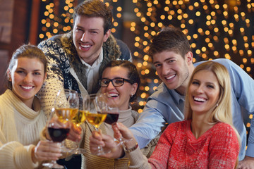 group of happy young people drink wine at party