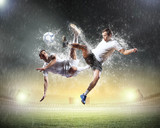 Fototapeta Sport - two football players striking the ball