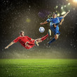 © Sergey Nivens - two football players striking the ball