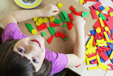 Preschool girl playing with puzzle