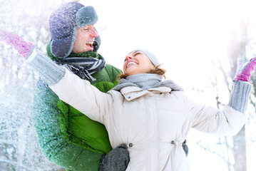 Wall Mural - Happy Couple Having Fun Outdoors. Snow. Winter Vacation