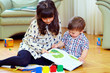 © Olesia Bilkei - elder sister playing with brother at home