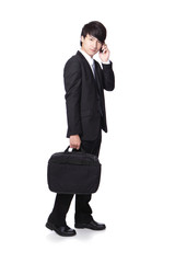 Wall Mural - Business man Walking while speaking mobile phon