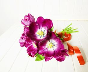 Wall Mural - bunch of purple tulips on a  white wooden table