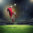 © Sergey Nivens - football player striking the ball