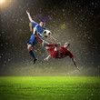 © Sergey Nivens - two football players striking the ball