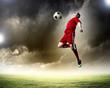 © Sergey Nivens - football player striking the ball
