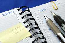 Write Some Notes On The Day Planner Isolated On Blue