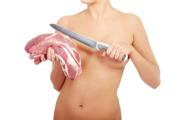 Nude woman holding big part of raw meat (pork neck).