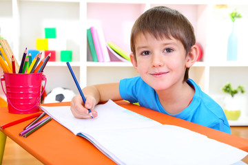 Wall Mural - Cute little boy drawing in his album