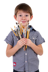 Wall Mural - Cute little boy with paintbrushes isolated on white