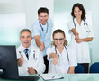 © Andrey Popov - Happy medical team giving a thumbs up