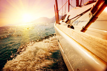 Yacht Sailing Against Sunset. Sailboat. Yachting. Sailing