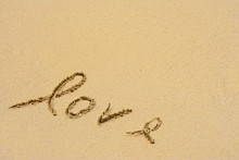 Conceptual Handwritten Love Text In Sand