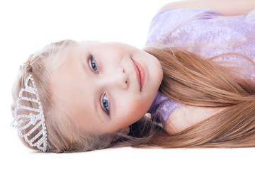 beautiful little girl lay with tiara on head