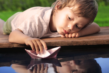 Wall Mural - paper ship in children hand