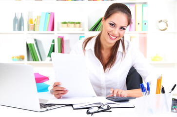 Wall Mural - Young pretty business woman with notebook in office