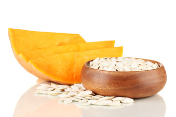 Pumpkin seeds  in wooden bowl isolated on the white