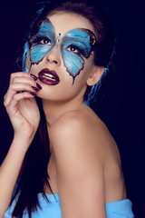 Fashion woman Portrait. Butterfly makeup,  face art make up