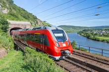 Intercity Train Leaving A Tunnel Near The River Moselle In Germa