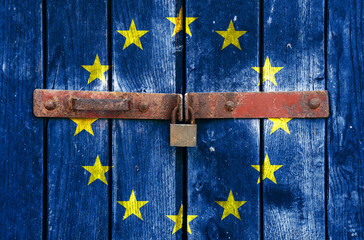 European Union flag on the background of old locked doors