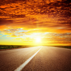 Wall Mural - red dramatic sunset over asphalt road