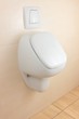 white urinal on beige tiled wall