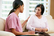 © Monkey Business - Nurse Discussing Records With Senior Female Patient at Home