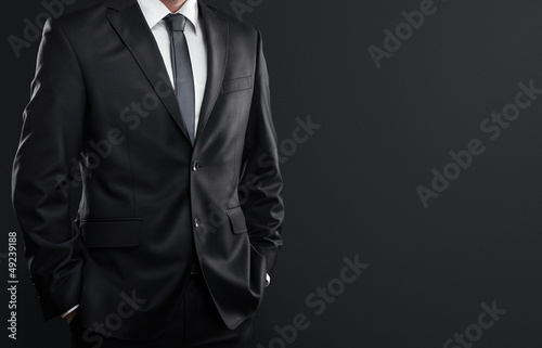 Cuadros en Lienzo Close up of businessman over dark gray background