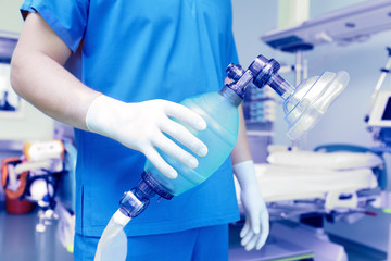 doctor holds breathing bag with face mask.