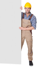 Wall Mural - Construction worker presenting empty banner