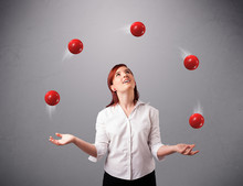 Young Girl Standing And Juggling With Red Balls