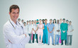 © WavebreakmediaMicro - Smiling doctor in front of a team of doctors standing together